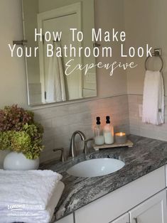 a bathroom sink with candles and towels on it