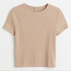 Short, Fitted Top In Soft Ribbed Jersey. Round Neck Line And Short Sleeves. Trendy Beige Top With Ribbed Neckline, Beige Summer Tops With Ribbed Neckline, Fitted Beige H&m Tops, Trendy Ribbed Beige Top, Trendy Beige Ribbed Top, Trendy Relaxed Fit Tops From H&m, H&m Ribbed Stretch Tops, Beige Ribbed Crew Neck Tops, Trendy H&m Tops Relaxed Fit