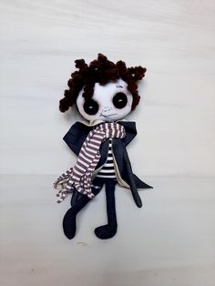 a stuffed animal doll with black and white stripes