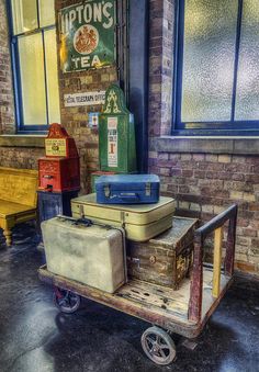 several suitcases are stacked on top of a cart