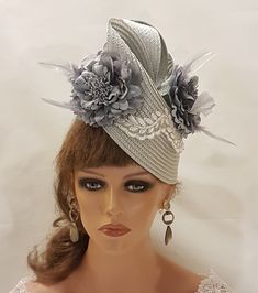 SilverGrey Hat Fascinator with Feathered Flowers, perfect for Royal Ascot, Kentucky Derby, Weddings Goodwood revival, Christening, Ascot or any special occasion. Gorgeous  Silver grey straw weave Hat fascinator with  SilverGrey Silk flowers adorned with a beautiful Leaf motif to the front  **Do you like to have this in any other custom colours, Please message. if possible with the dress picture* This hat has been made by hand and very light to wear. This hat is designed to be worn tilted on the side of the head with  long  Quill feather and the Flowers with feather detail for a beautifull Glamorous look. Attachment option: Alice band (BY DEFAULT HEADBAND WILL BE BLACK SATIN COVERED. IF YOU LIKE TO HAVE IN BROWN,BEIGE/CREAM, SILVERGREY OR OTHER COLOURS PLEASE ADD A NOTE AT CHECKOUT) Gray Brimmed Hat For Kentucky Derby, Gray Short Brim Hat For Kentucky Derby, Elegant Gray Summer Hat, Gray Summer Party Hat, Summer Gray Party Hat, Silver Adjustable Fascinator For Church, Gray Brimmed Party Hat, Elegant Gray Hat With Short Brim, Gray Hat For Kentucky Derby Party