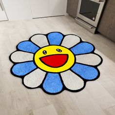 a blue and white rug with a smiley face on it in the middle of a kitchen