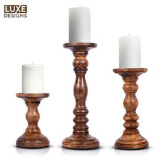 three wooden candlesticks sitting next to each other