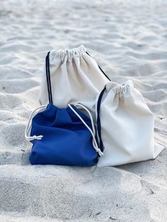 "These Waterproof cotton Swim Bags are perfect for wet or damp clothes. You will find them irreplaceable when going to pool for swimming lessons, using them for nappy bags or taking to the beach for wet bikini. They have drawstring rope straps, IF YOU WANT ME TO ADJUST STRAPS TO WEAR A BAG AS A BACKPACK - write this in \"Note to seller\" section, or message me. This water resistant bag is pretty, stylish, neat, multi-purpose, practical. Reusable wet bag eco-minded and sustainable option for stor Nylon Bags For Beach Season, Blue Nylon Beach Bag, Durable Beach Bags For Beach Season, Blue Swimwear For Beach Season Travel, Nylon Beach Bag For Beach Season, Nylon Beach Bag, White Reusable Beach Bag, Blue Tote Bag For Poolside, White Casual Bag For Poolside