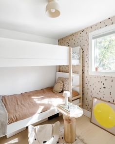 a bedroom with bunk beds and wallpaper on the walls