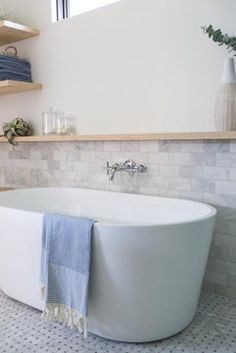 a white bath tub sitting next to a window