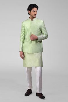 Sage green bandhgala jacket crafted in pure matka silk with embroidery details. Paired with a kurta and pant.
Components: 3
Pattern: Embroidered
Type Of Work: Thread
Neckline: Band collar
Sleeve Type: Long
Fabric: Silk
Color: Green
Other Details: 
Attached lining
Length:
Bandhgala: 29 inches and Sleeves: 25.5 inches
Kurta: 40 inches and Sleeves: 25 inches
Pant: 40 inches
Occasion: Mehendi and Puja - Aza Fashions Festive Silk Bandhgala With Naqshi Details, Silk Bandhgala For Festive Reception, Festive Silk Bandhgala With Naqshi, Silk Bandhgala For Reception And Festive Occasions, Green Bandhgala With Resham Embroidery For Festivals, Silk Bandhgala For Eid Reception, Unstitched Green Bandhgala For Festivals, Green Bandhgala With Zari Work For Eid, Formal Pista Green Sets With Chikankari Embroidery