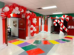 an office decorated for christmas with candy canes and balloons