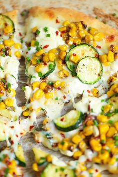 a pizza topped with cucumbers, cheese and other toppings