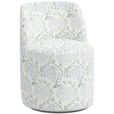 an upholstered chair with blue and green flowers on the back, against a white background