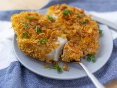 a white plate topped with food and a fork