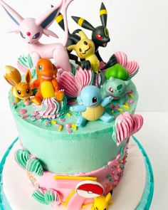 a cake decorated with pokemon figurines on top of it