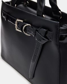 The ROXANNE Bag is a sophisticated and stylish structured belted satchel, perfect for adding a touch of tailored elegance to your look. Made with quality craftsmanship, this bag is sure to elevate any outfit. Structured top handle satchel bag Sculptural gusset detail Belt detail with 2D rings and knot Detachable crossbody strap Bridge closure with mag snap Top handle: 4 inches Crossbody strap: 24 inches 8.75in H x 13in W x 3in D Synthetic materials Imported Workwear Shoulder Bag With Silver-tone Hardware, Workwear Shoulder Bag With Double Handle And Silver-tone Hardware, Double Handle Shoulder Bag With Silver-tone Hardware, Business Satchel Briefcase With Metal Hardware, Classic Work Bags With Metal Hardware, Classic Workwear Bags With Metal Hardware, Chic Business Bags With Adjustable Handle, Chic Business Bag With Adjustable Handle, Business Briefcase With Metal Hardware Satchel