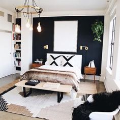 a bed room with a neatly made bed and a large mirror on the wall above it