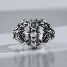 Is your loved one a real biker? Do you feel that he needs more shiny motorcycle jewelry for his collection? Something that will be a piece of art in his collection, not just another item that he wears every day? This Silver wedding ring is ideal for both men and women who love the motorbike themed designs as well as unique gothic style. It is made from 925 Sterling silver, so it's really durable you can wear it daily without fear of damaging it or losing it. It has great details which make it lo Silver Stainless Steel Biker Jewelry, Black Biker Style Ring As Gift, Biker Style Stainless Steel Jewelry For Biker Events, Biker Skull Ring For Biker Events, Black Biker Rings For Biker Events, Silver Biker Jewelry For Streetwear, Vintage Silver Skull Ring For Biker Events, Silver Biker Skull Ring For Biker Events, Motorcycle Jewelry