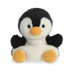 a black and white stuffed penguin with yellow feet