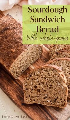 a loaf of sourdough sandwich bread on a cutting board with text overlay that reads sourdough sandwich bread with whole - grains