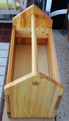 a wooden box with two candles in it