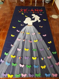 a wedding dress made out of tulle with butterflies on the floor and in front of it