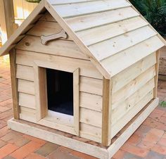 a dog house made out of wood with a roof