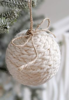 an ornament hanging from a christmas tree with twine and rope on it