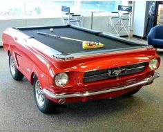 an old red car with a pool table on the front and bottom, says because these are the only balls a ford will ever have