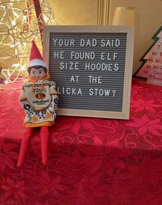 an elf is next to a sign that says your dad said he found ele size hoddles at the licka show