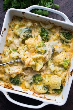 a casserole dish with broccoli and cheese in it on a table