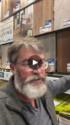 a man with grey hair and glasses in a store