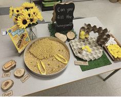 a table topped with fake sunflowers and other items on top of the table