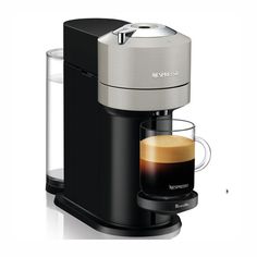 an espresso machine with a cup of coffee next to it