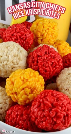 some rice krispies are in a white bowl with red, yellow and orange toppings