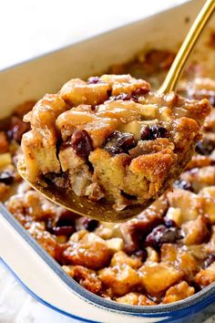 a spoon full of baked bread pudding with raisins