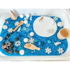 a tray filled with different types of toys and snowflakes on top of it