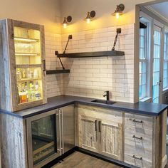 a kitchen with white brick walls and wooden cabinets