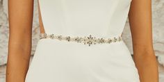 Rhinestone Wedding Belt Sash BT2471 Complete your modern bridal ensemble with this charming rhinestone and pearl beaded belt by enVogue. Featuring a delightful beaded design on organza ribbon, this dainty belt will be an enchanting complement to your wedding gown. Belt self-ties with ivory organza ribbon ties. Size: Total ribbon length is 84" long. Design size is 13.5" long and 1.25" wide at the center peak. Color: Ivory/Silver. Style: BT2471. Please allow 1 week for delivery. Shipping Policy . Elegant Beaded Silver Sashes, Elegant Silver Beaded Sash, Elegant Crystal Wedding Sashes, Elegant Crystal Bridal Belt, Elegant Beaded Bridal Belt, Elegant Beaded Fitted Bridal Belt, Elegant Embellished Sashes, Elegant Rhinestone Bridal Belt For Bridesmaids, Elegant Silver Bridal Belt For Bridesmaids