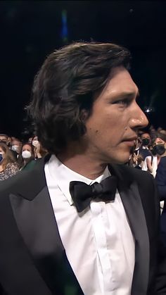 a man in a tuxedo and bow tie at an event