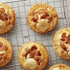 six small pies on a cooling rack with some toppings in the top right corner