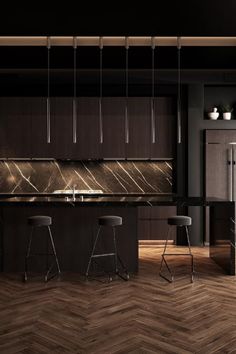 a kitchen with wooden floors and black cabinets