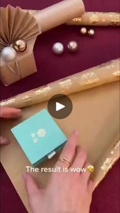 the person is wrapping presents in brown paper