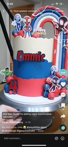 a spiderman themed cake with the name comic on it and stickers all over