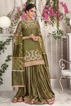 Opt for this stunning olive hued ensemble featuring multi colored floral embroidery further enhanced with dabka, sequins and beads, paired with jacquard cotton net gharara and beautifully composed dupatta with heavy sequin and gota embellishments. Hand crafted tassels completes the look. Shirt Fabric: Cotton NetShirt Length: 34” (customisable, mention in order notes)Sleeves: 11” (customisable, mention in order notes)Gharara Fabric: Jacquard Cotton NetDupatta Fabric: NetShirt , Gharara & Dupa Pakistani Formal Dresses, Nikkah Dress, Designer Outfit, Fancy Kurti, Formal Wear Dresses, Pure Chiffon, Suits Design, Dress Classy, Indian Suits