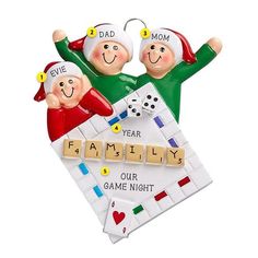 a christmas ornament with two people playing scrabbles and the words family on it