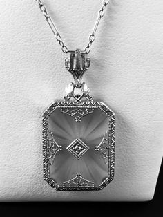 "A lovely and very feminine 1930's vintage necklace featuring a frosted pressed glass plaque-known as Camphor Glass. Delicate lacy platinum filigree sets the background for a single tiny twinkling diamond in the center.The pendant is topped with a matching filigree crown-like bail. Inside the bail is stamped \"Plat\" The pendant comes with the original 14k antique chain, although I would not trust this chain , because of it's age and condition to be able to withstand any type of wear. I can prov Camphor Glass Jewelry, Lalique Jewelry, Travelers Rest, White Gold Chain, Pendant Diamond, Glass Jewellery, Sparkly Things, Filigree Pendant, Pressed Glass