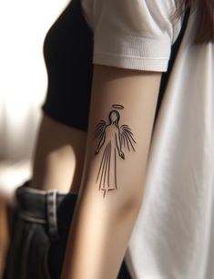 a woman's arm with an angel tattoo on the left side of her arm