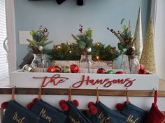 christmas stockings hanging on a shelf with the word tish