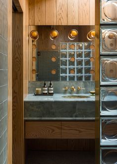 there is a washer and dryer in the bathroom with glass doors on the wall