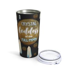 a travel mug with the words crystal golds on it next to a white lid