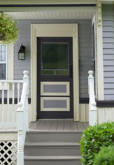 the front door of a house with steps leading up to it