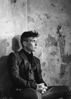 black and white photograph of a man sitting on a chair